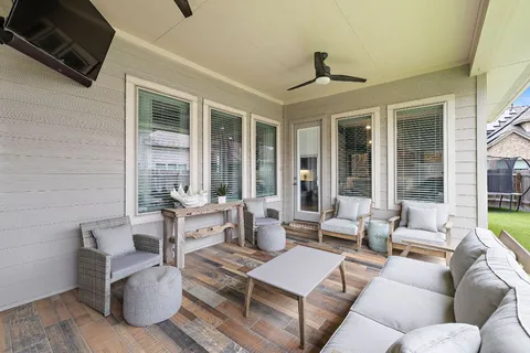 a living room with furniture and floor to ceiling windows