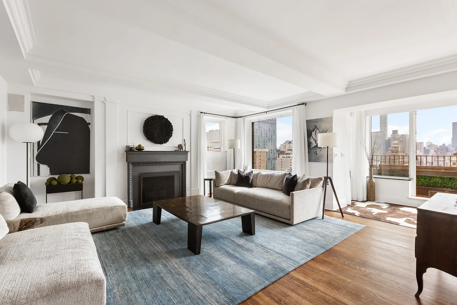 a living room with furniture a fireplace and a floor to ceiling window