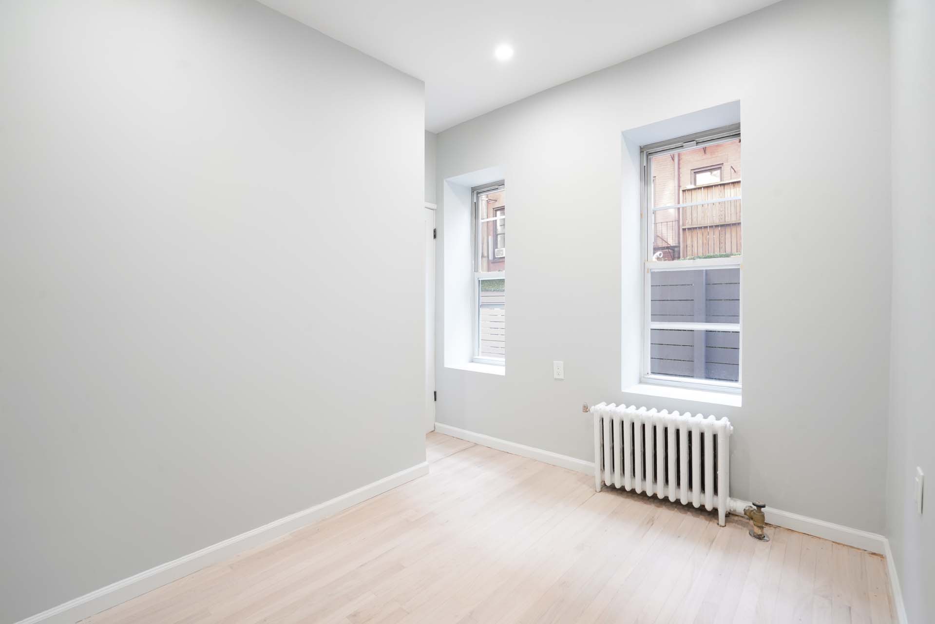 210 West 10th Street, Unit 1C Manhattan, NY 10014 - Photo 4 of 6 an empty room with windows