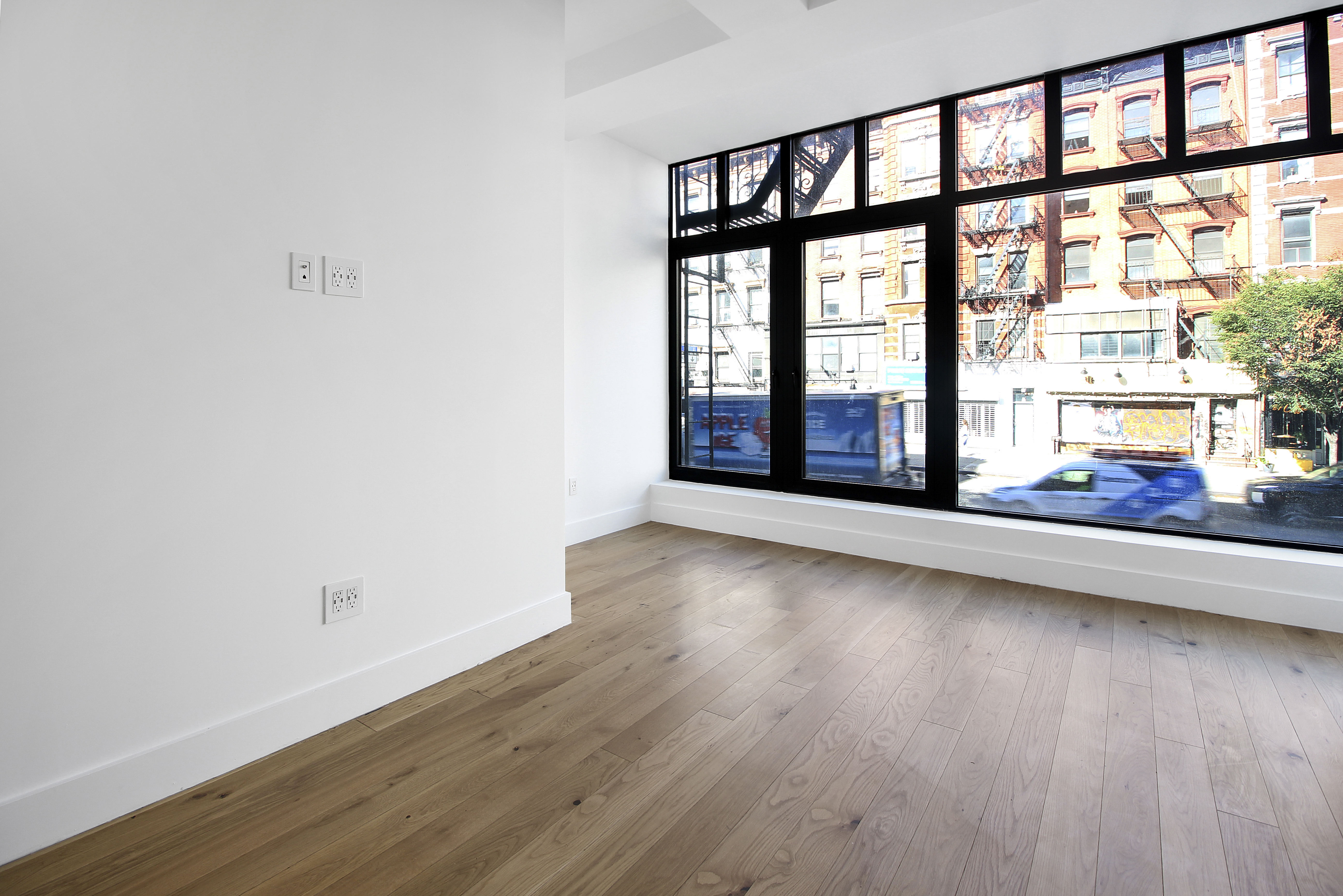 100 2nd Avenue, Unit 2 Manhattan, NY 10003 - Photo 5 of 10 wooden floor in an empty room with a window