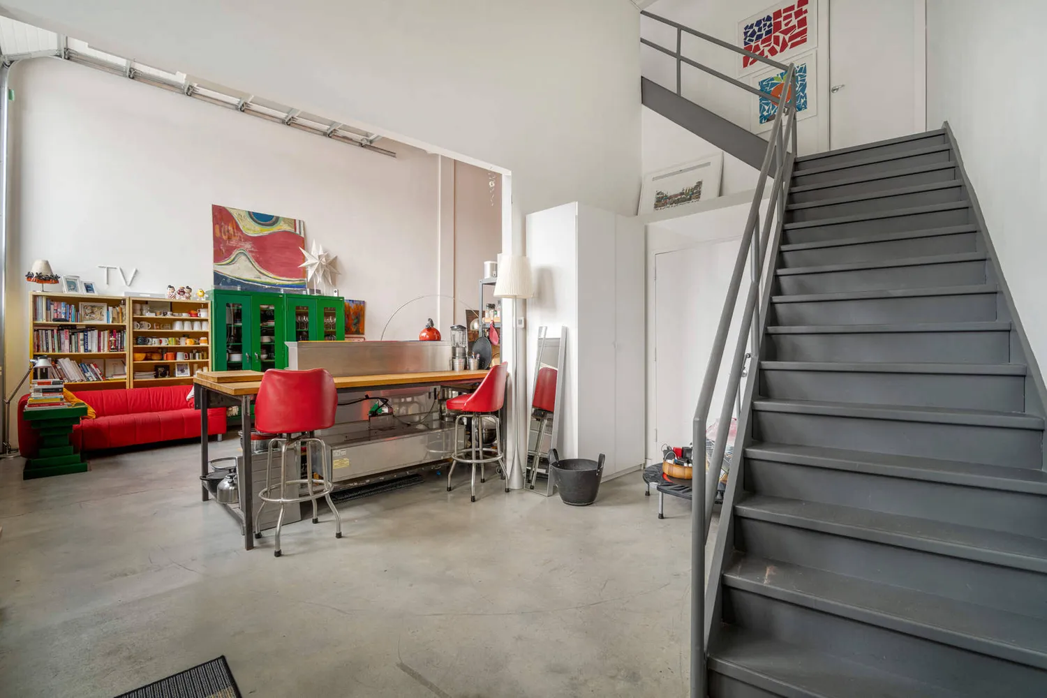 a living room with furniture and stairs