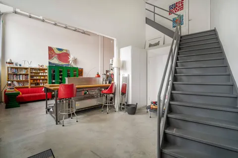 a living room with furniture and stairs