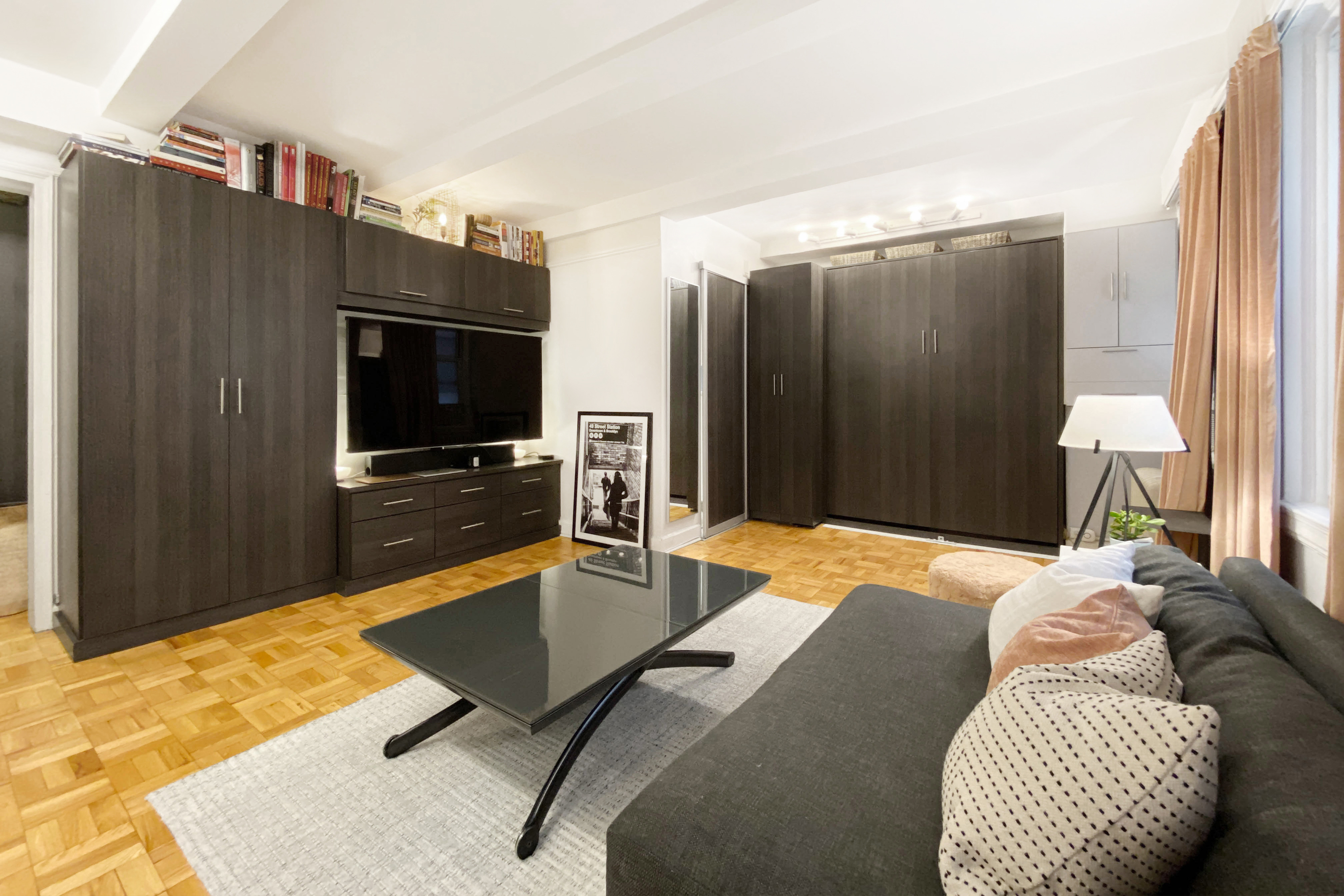 155 East 49th Street, Unit 1E Manhattan, NY 10017 - Photo 3 of 8 a bedroom with a bed and furniture