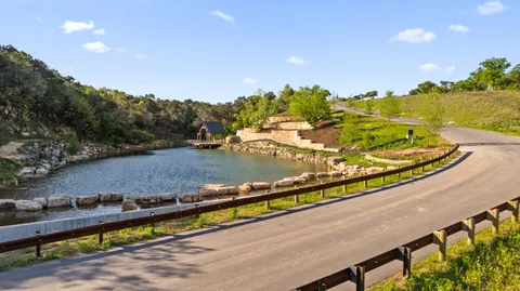 a backyard of a house with a yard and outdoor seating
