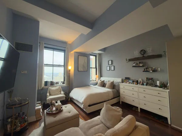 a bedroom with furniture and a window