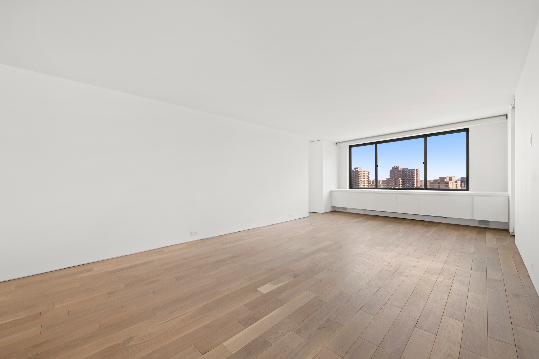 530 East 72nd Street, Unit 14E Manhattan, NY 10021 - Photo 4 of 19 a view of an empty room with wooden floor and a window
