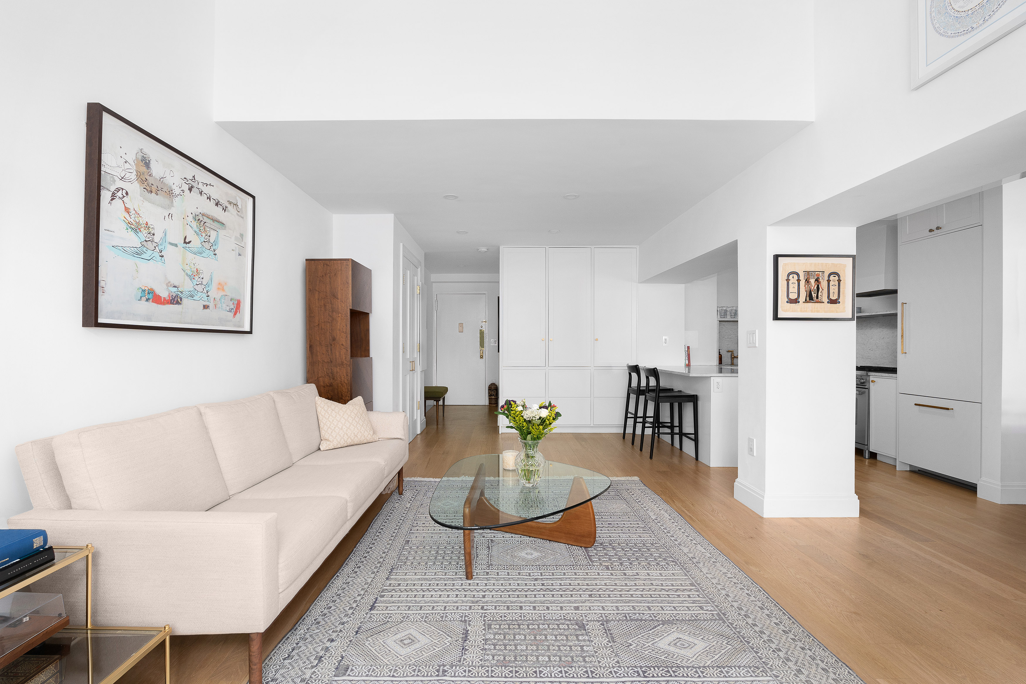 77 Bleecker Street, Unit 123E Manhattan, NY 10012 - Photo 2 of 13 a living room with furniture and wooden floor
