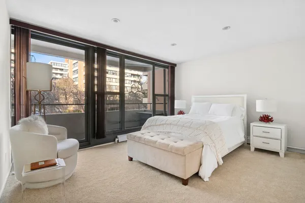 a bedroom with a bed and a large window