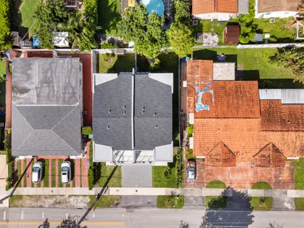 an aerial view of a houses with street