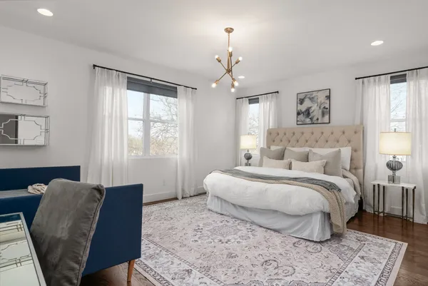 a bed room with a bed and a chair