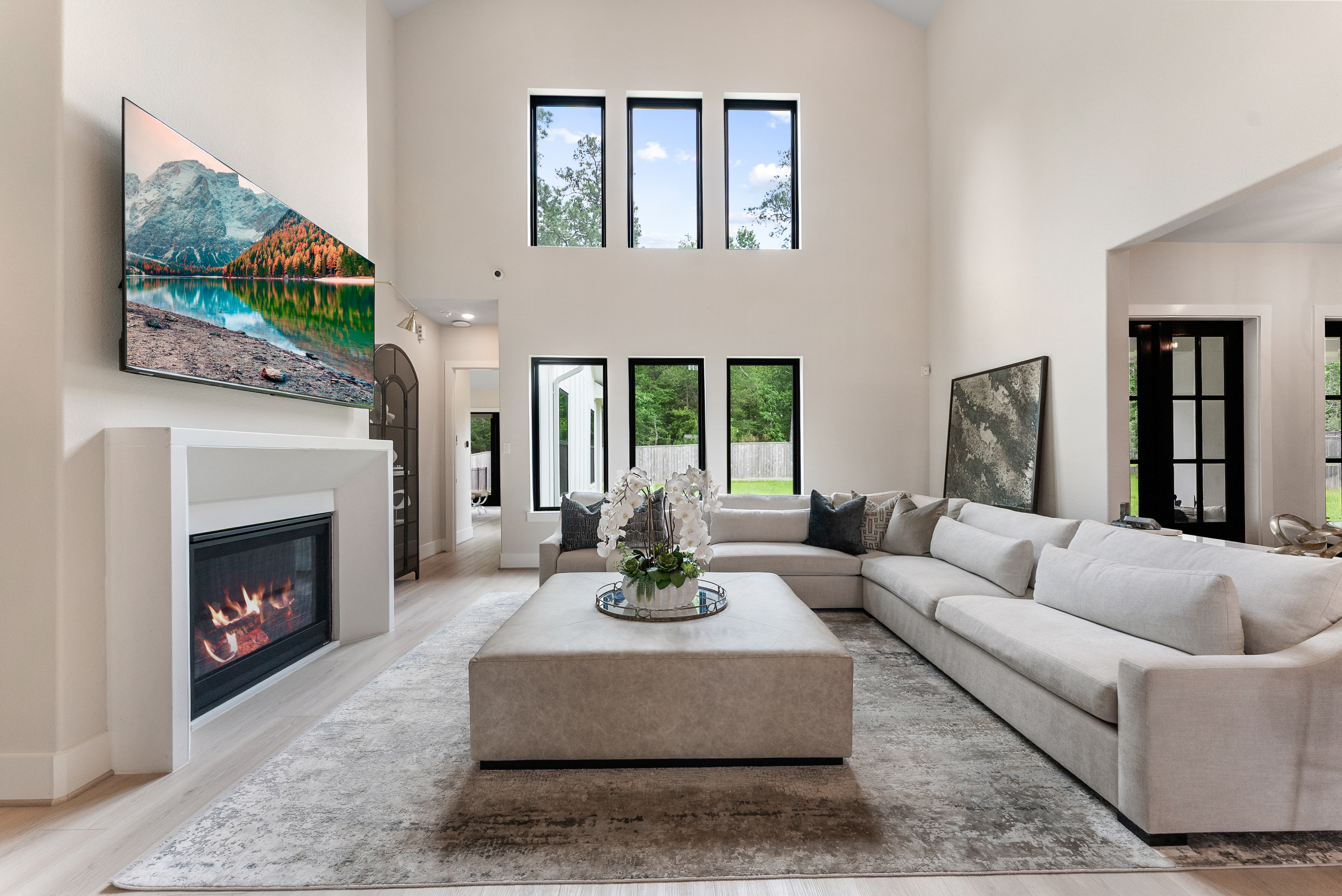 2118 Bennet Court Conroe, TX 77384 - Photo 12 of 70 a living room with furniture a flat screen tv and a fireplace