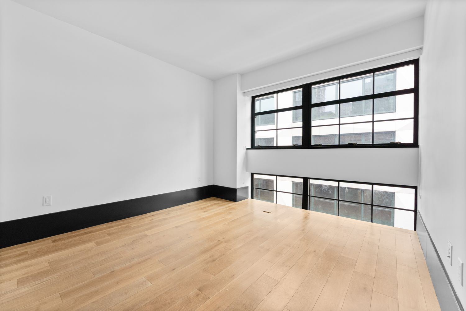 a large bed sitting in a bedroom next to a window