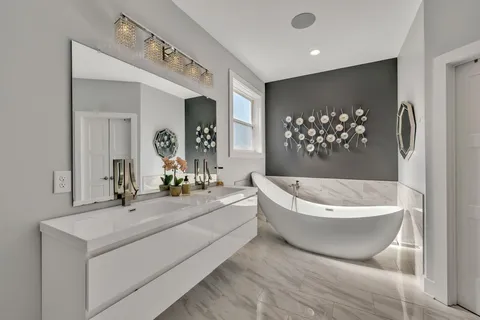 a bathroom with a bathtub and a mirror