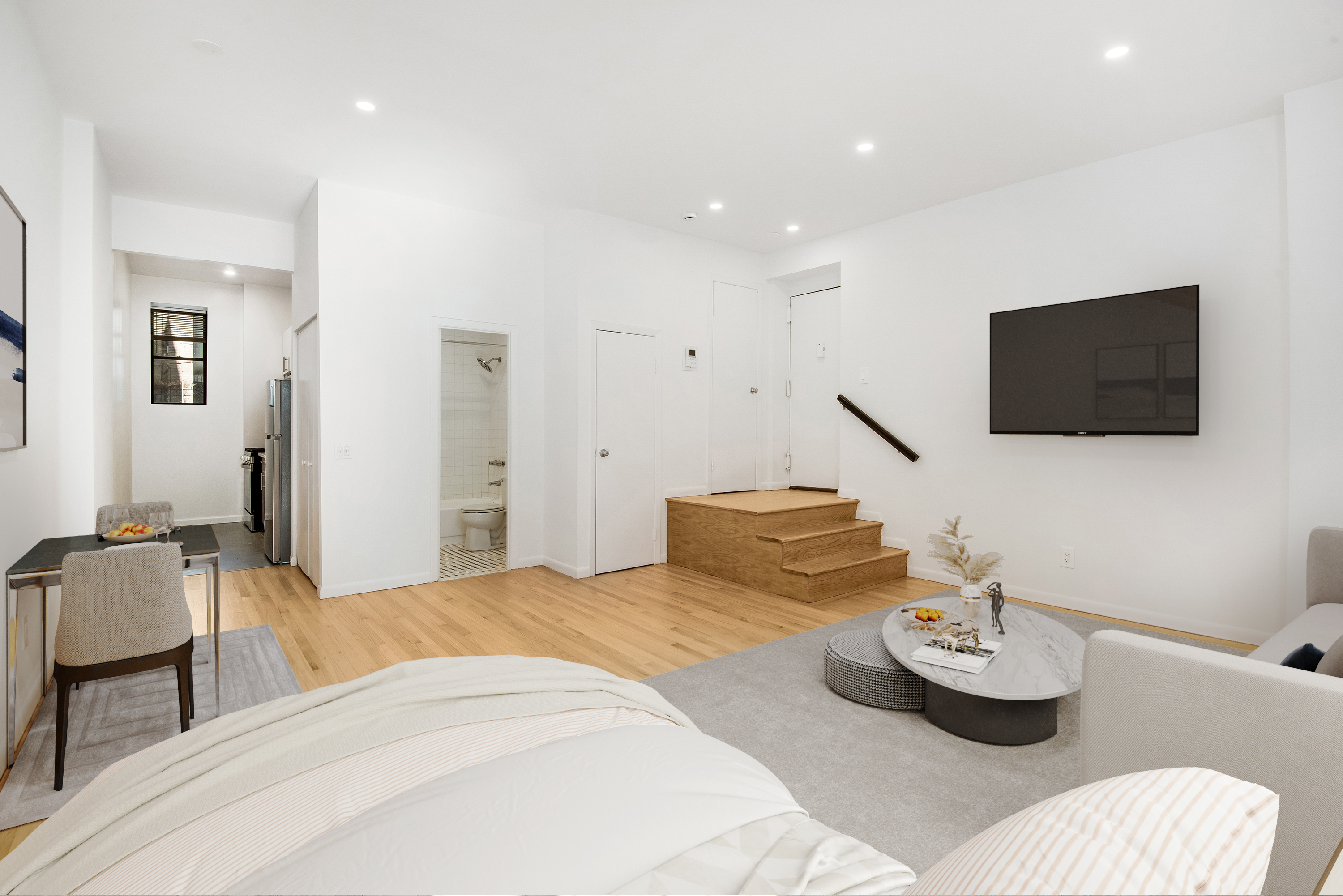 182 East 2nd Street, Unit 1E Manhattan, NY 10009 - Photo 3 of 14 a bedroom with bed and a flat screen tv