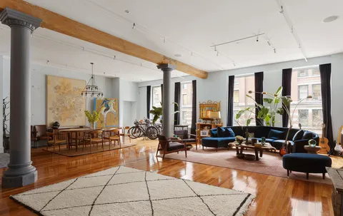 a living room with furniture and floor to ceiling window