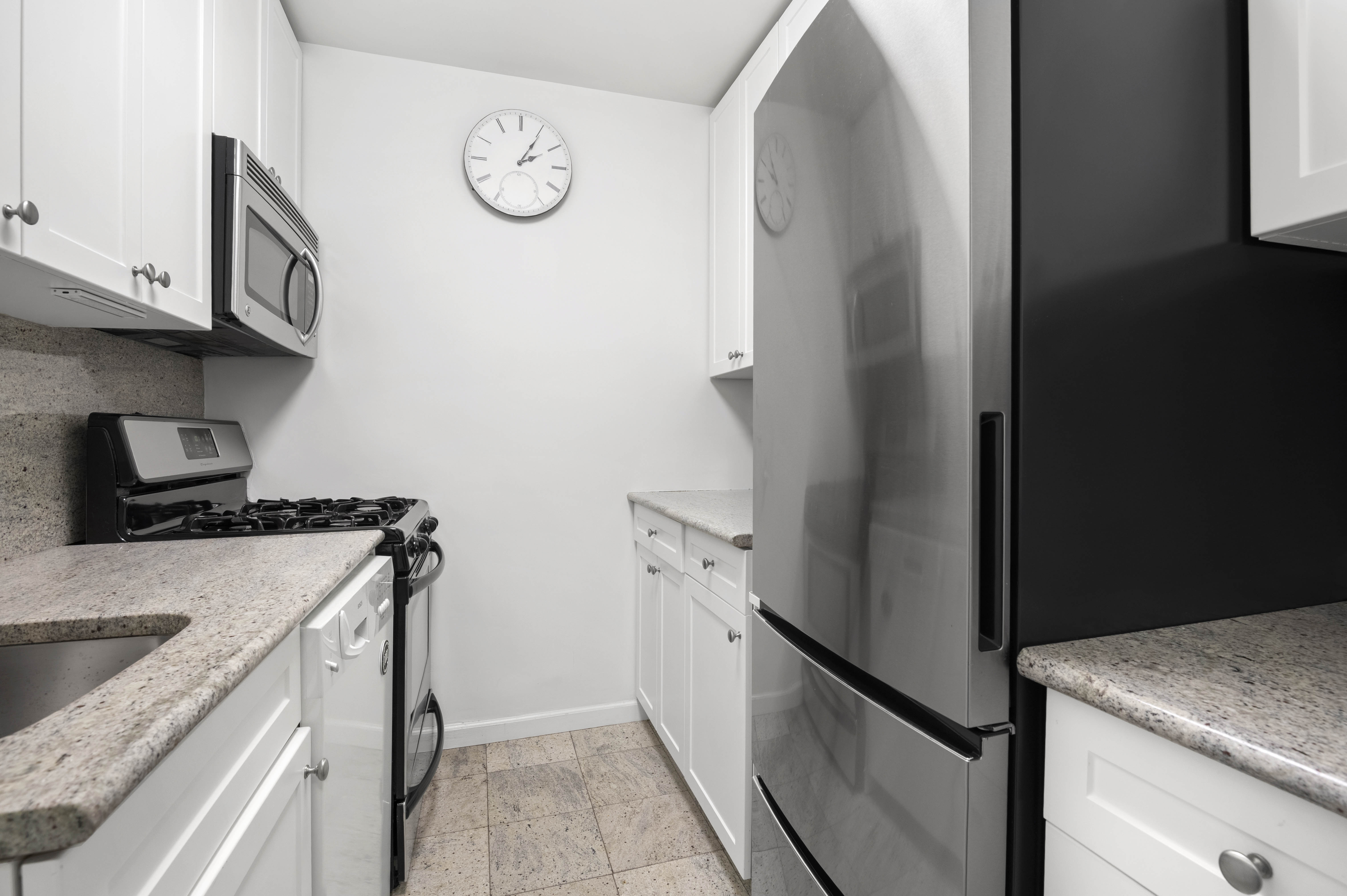 165 West End Avenue, Unit 5A Manhattan, NY 10023 - Photo 4 of 17 a kitchen with a stove and a refrigerator