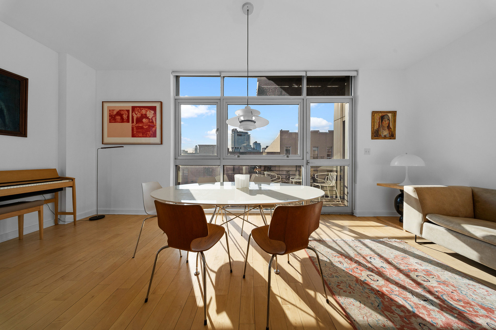 a view of a dining room with furniture window and wooden floor