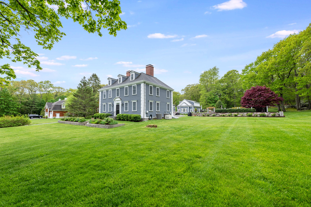 79 Pine Street Dover, MA 02030 - Photo 2 of 25 a front view of a house with garden