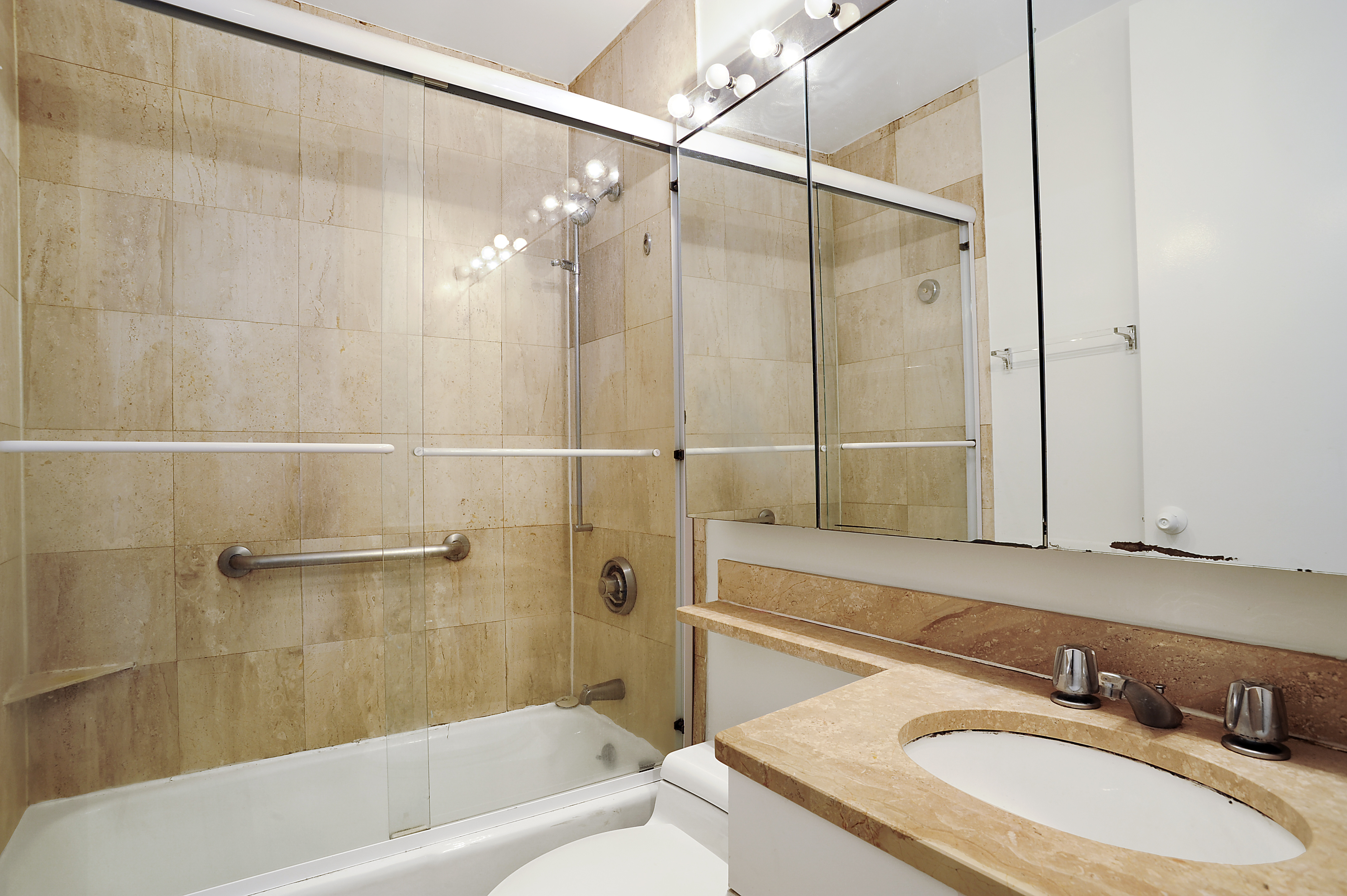 350 West 50th Street, Unit 4ZZ Manhattan, NY 10019 - Photo 4 of 5 a bathroom with a sink a toilet and shower