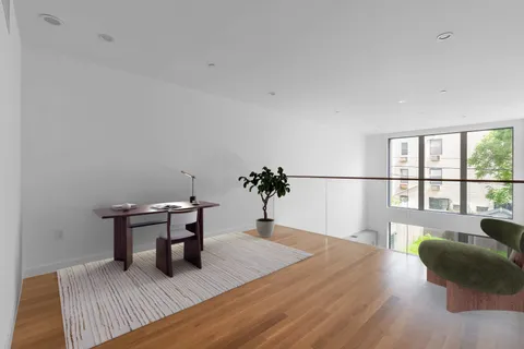 a bedroom with furniture and a wooden floor