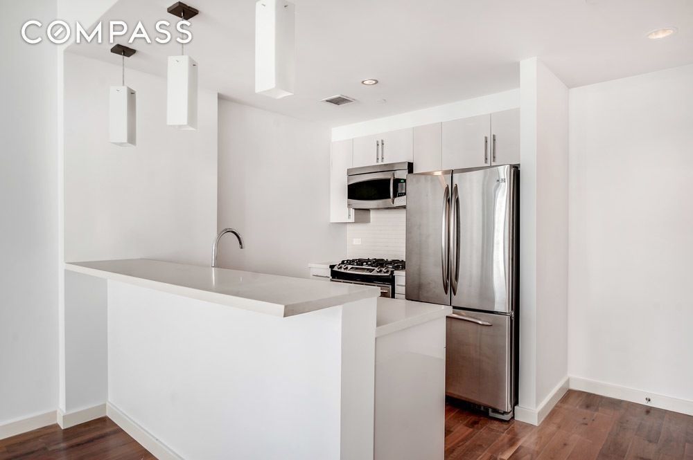 125 North 5th Street, Unit 2A Brooklyn, NY 11249 - Photo 2 of 10 a kitchen with stainless steel appliances a refrigerator and a stove