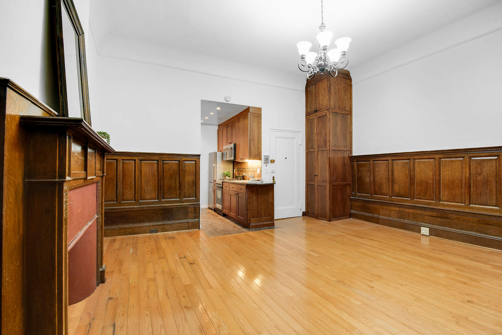 310 West 98th Street, Unit 1B Manhattan, NY 10025 - Photo 4 of 11 a view of a kitchen with wooden floor and staircase