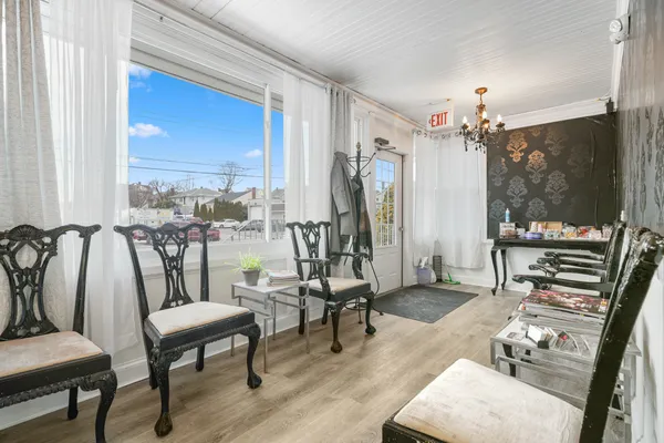 a living room with furniture and a floor to ceiling window