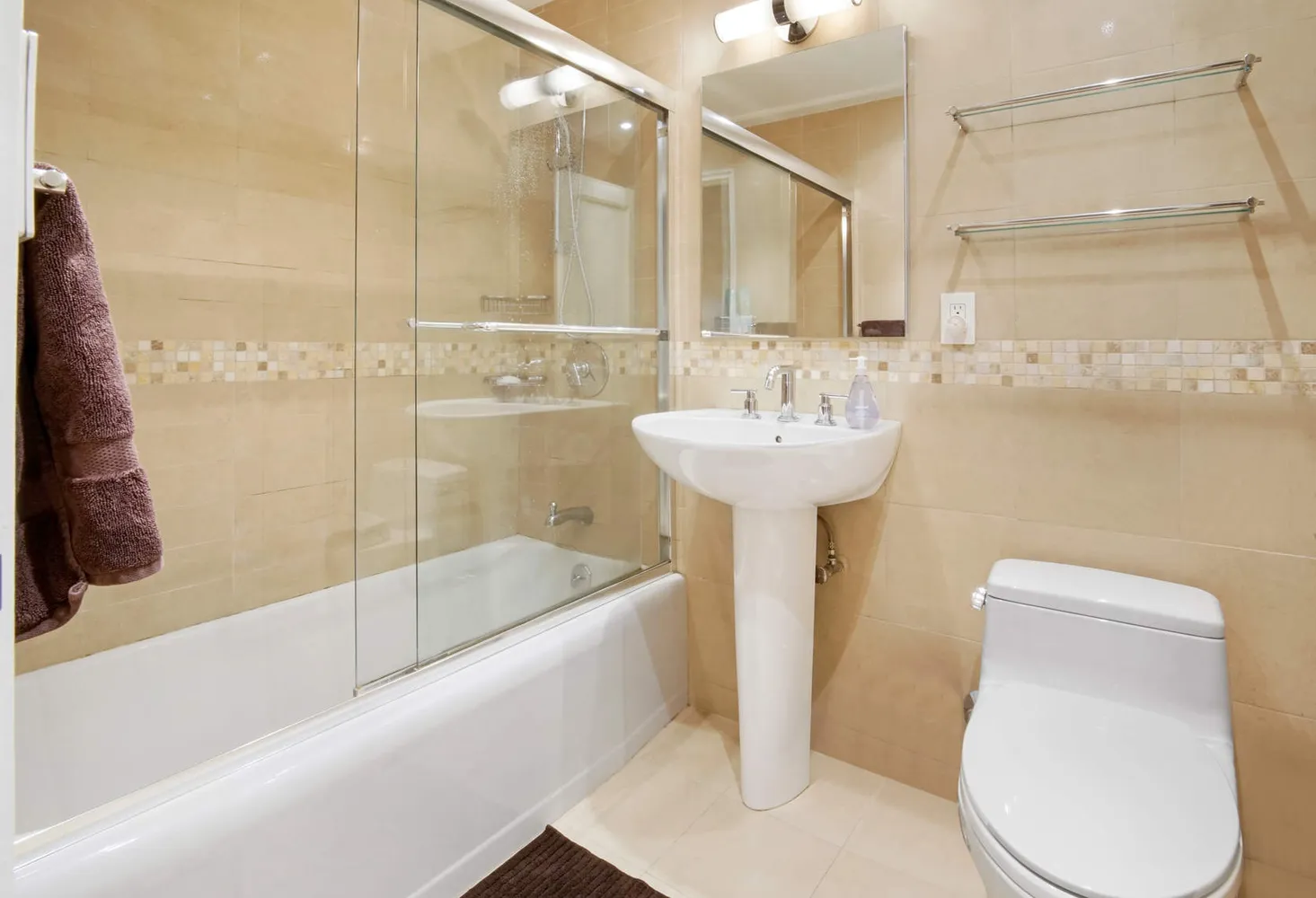 a bathroom with a sink a toilet and shower