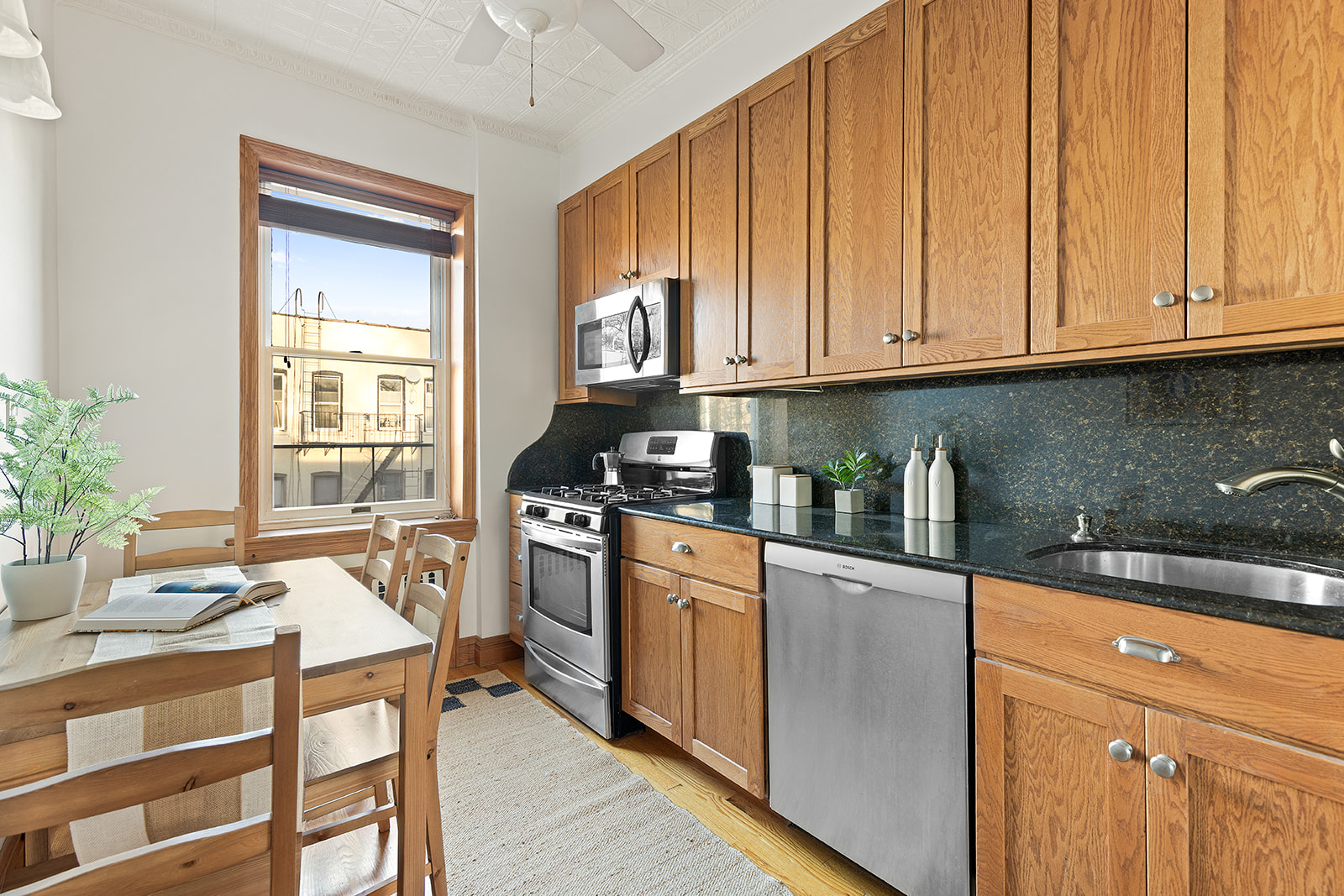 521 84th Street Brooklyn, NY 11209 - Photo 10 of 19 a kitchen with stainless steel appliances granite countertop a stove a sink dishwasher and cabinets with wooden floor
