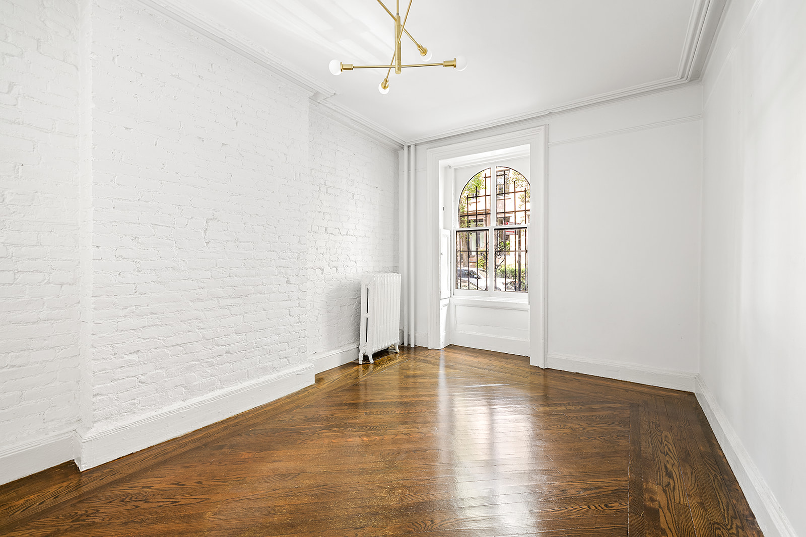 166 Congress Street, Unit A Brooklyn, NY 11201 - Photo 5 of 9 a view of an empty room with wooden floor and a window