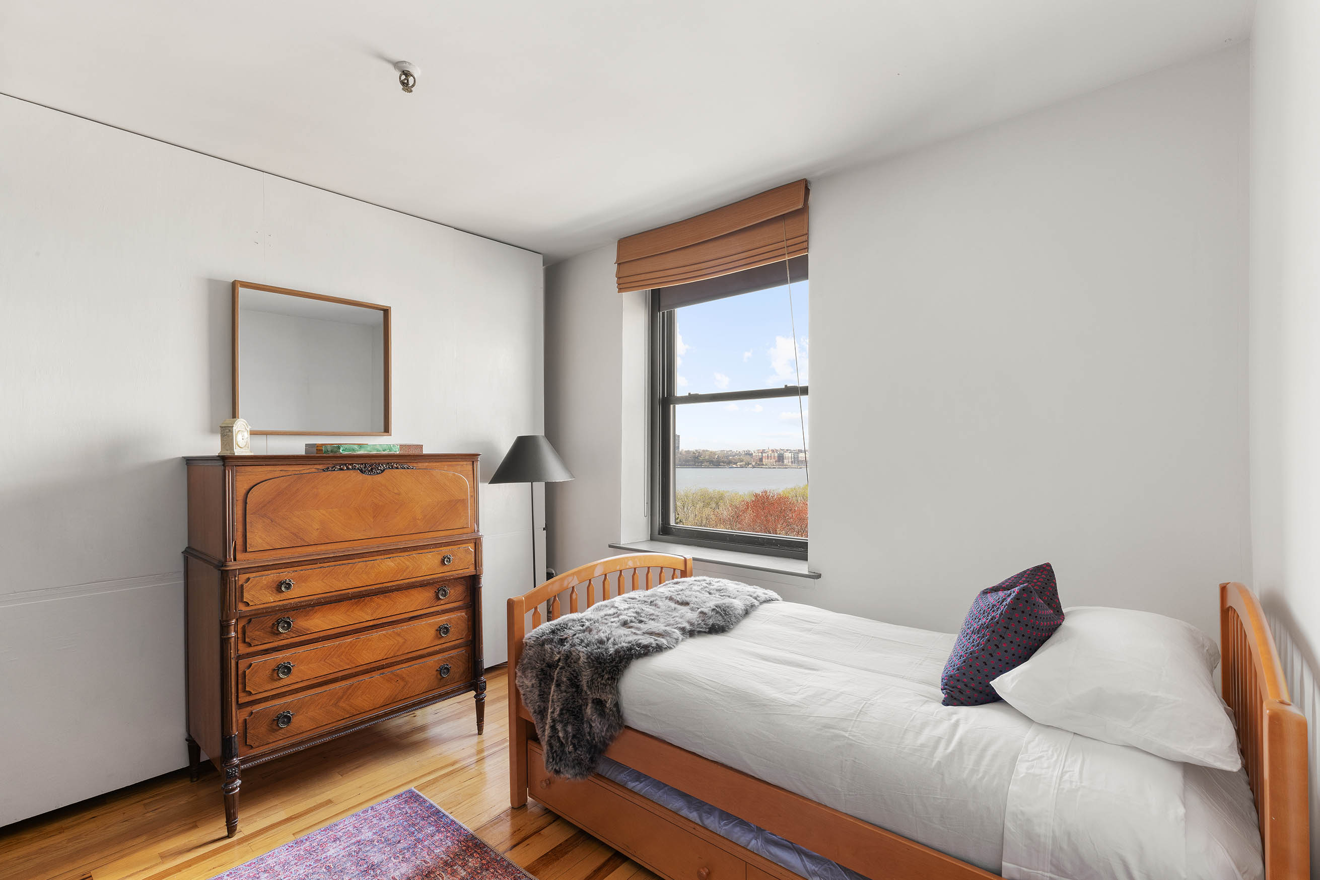 166 Bank Street, Unit 6B Manhattan, NY 10014 - Photo 9 of 16 a bedroom with a bed and a window