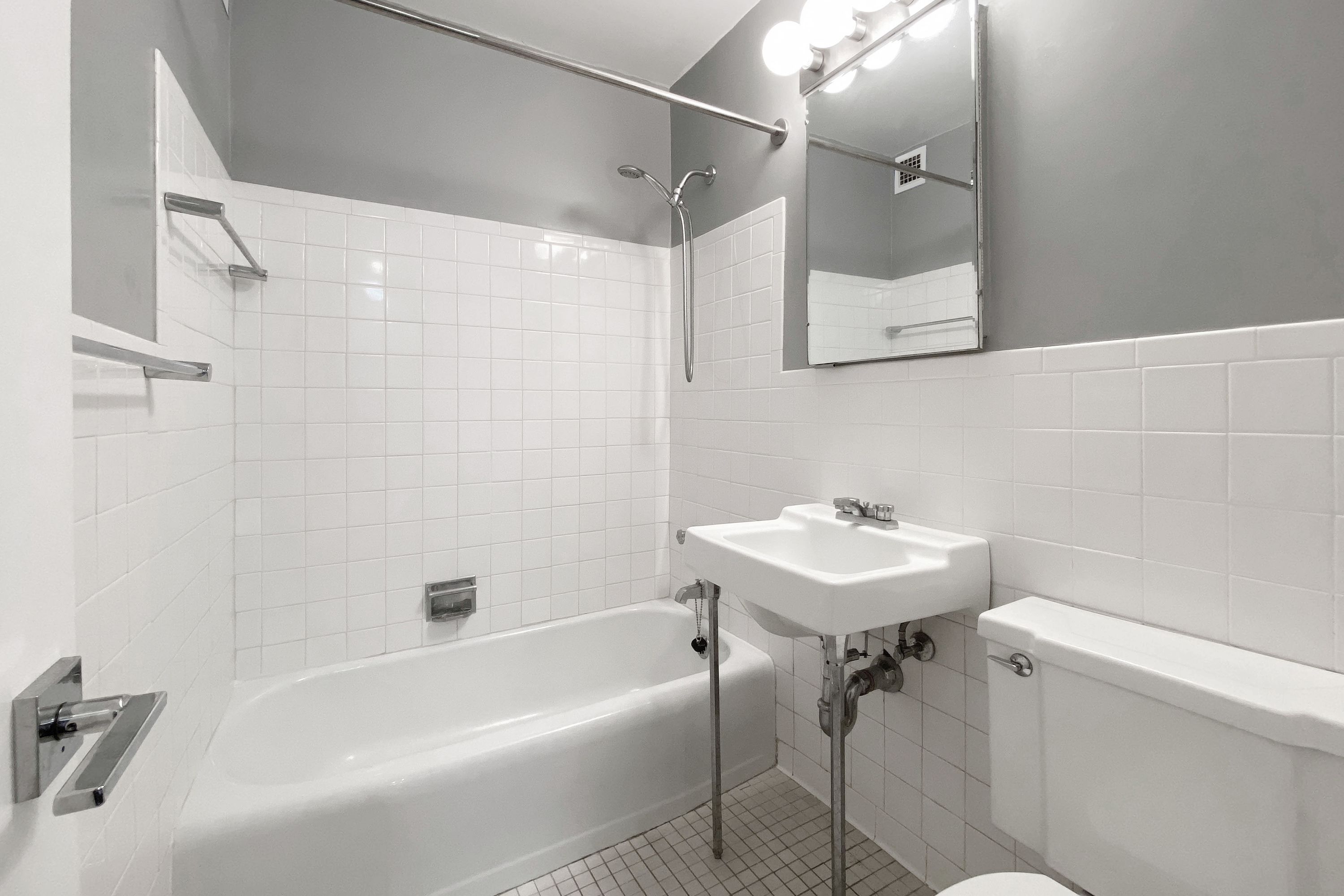 330 East 33rd Street, Unit 3F Manhattan, NY 10016 - Photo 6 of 15 a bathroom with a sink mirror toilet and bathtub