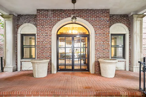 a view of a brick house with entryway door