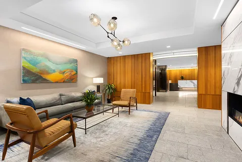 a living room with furniture and a chandelier