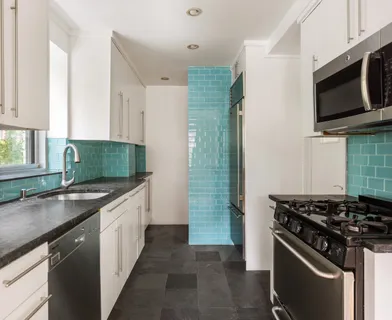 a kitchen with stainless steel appliances a sink stove and microwave