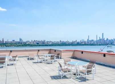 a view of a lake with outdoor seating and city view