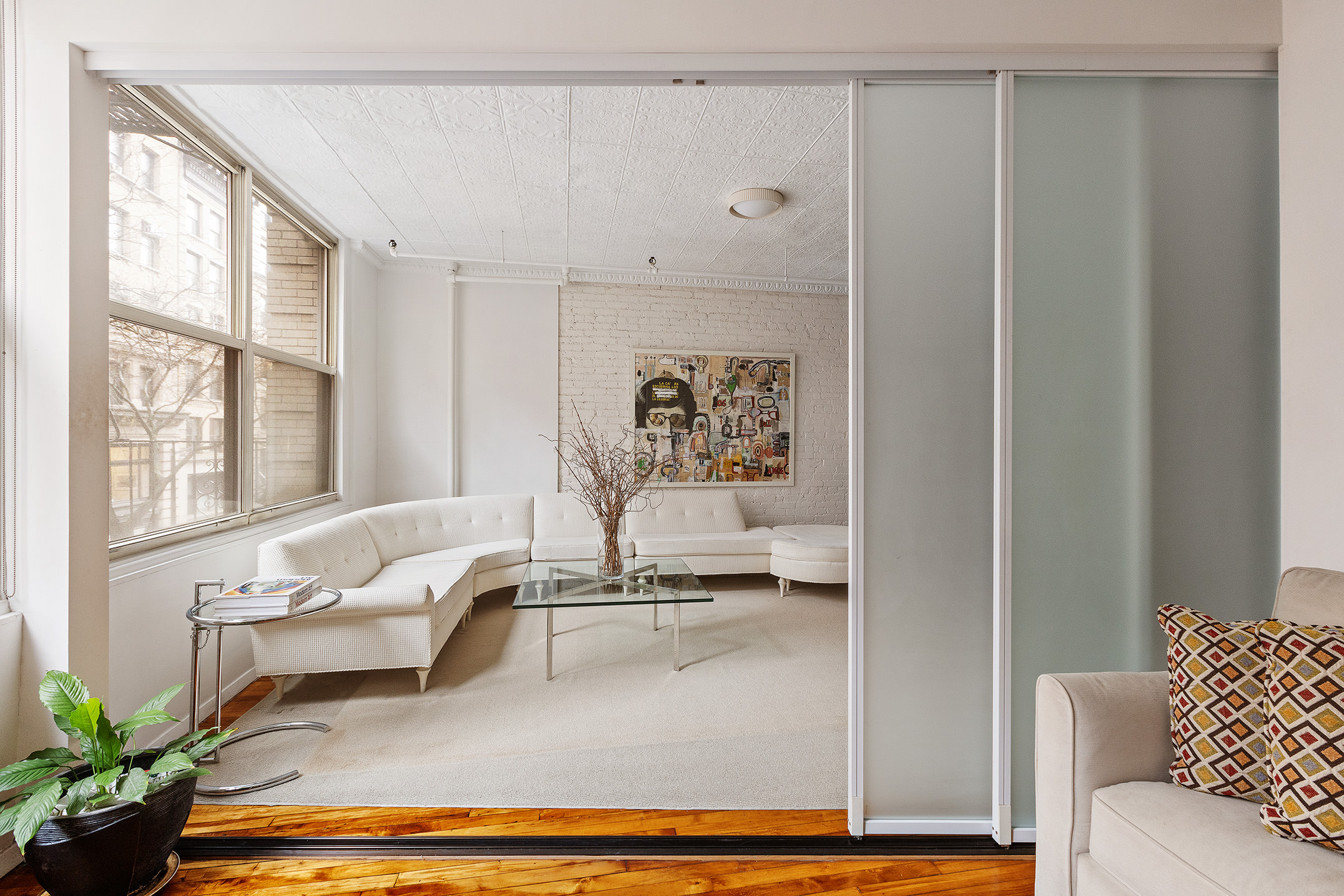 25 West 15th Street, Unit 3 Manhattan, NY 10011 - Photo 6 of 19 a living room with furniture and a large window