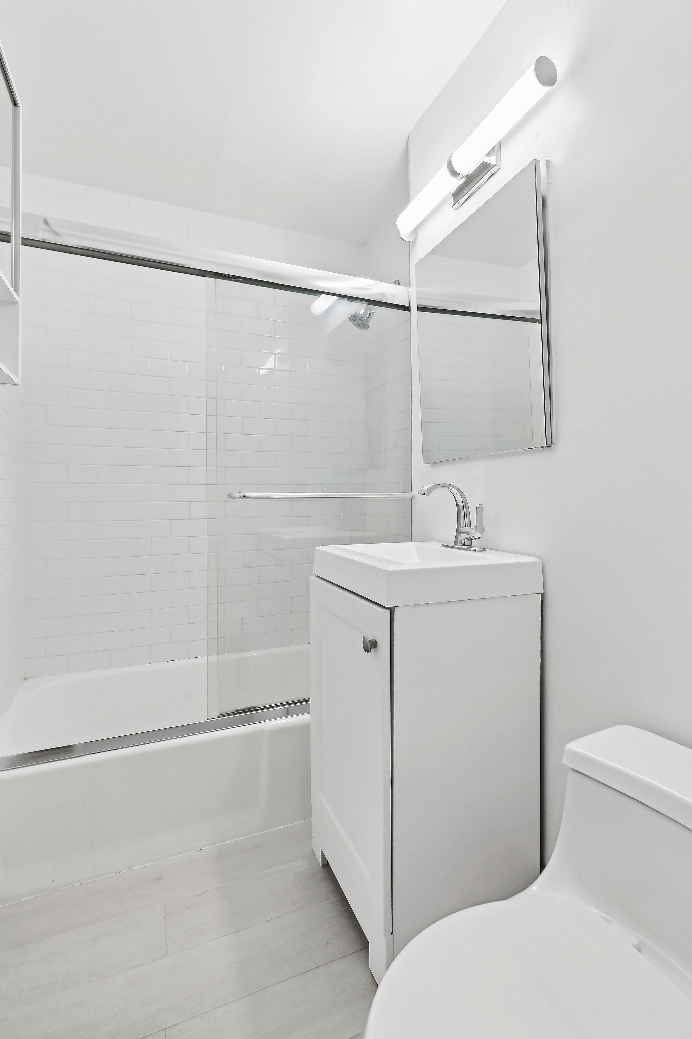 314 West 56th Street, Unit 4E Manhattan, NY 10019 - Photo 5 of 11 a bathroom with a sink toilet and shower