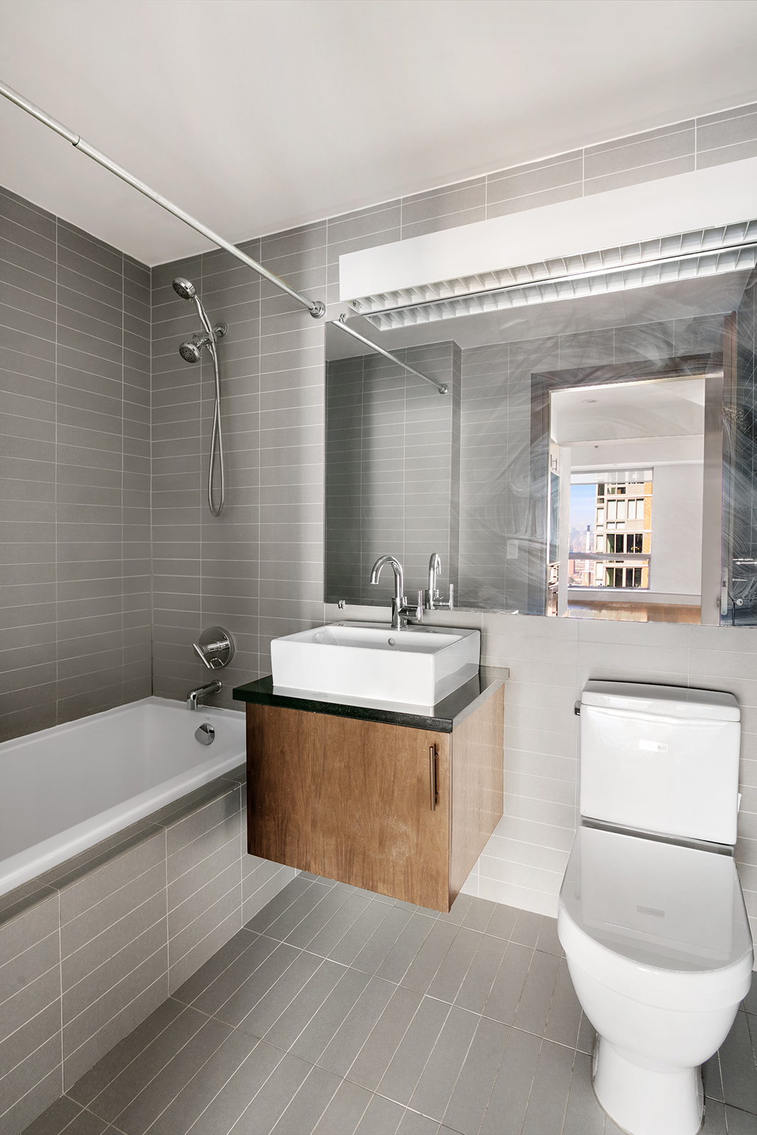 150 Myrtle Avenue, Unit 1902 Brooklyn, NY 11201 - Photo 4 of 27 a bathroom with a sink a toilet and a bathtub