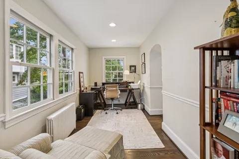 a living room with furniture a window and a book shelf
