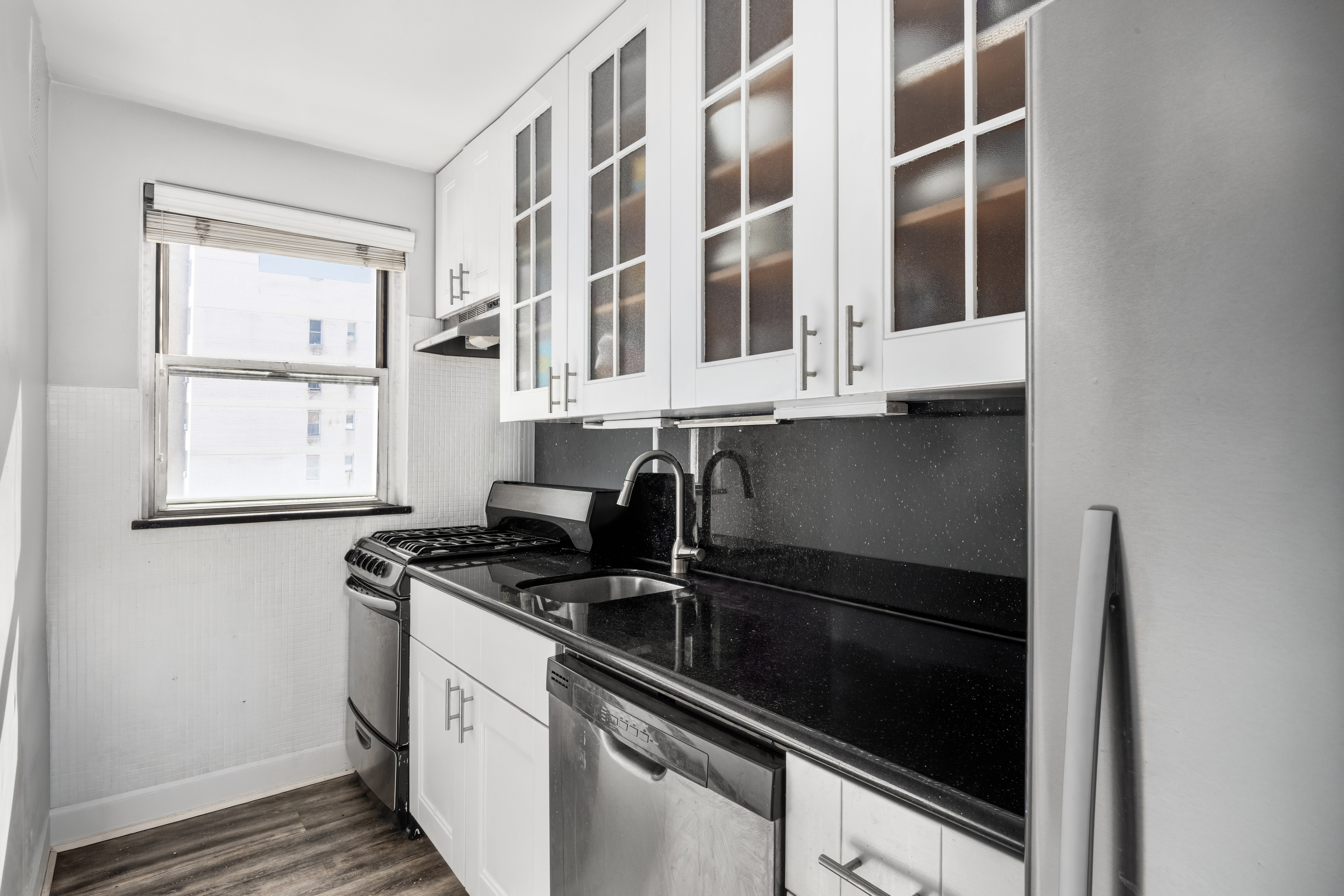 201 East 37th Street, Unit 11B Manhattan, NY 10016 - Photo 4 of 6 a kitchen that has a sink and a stove