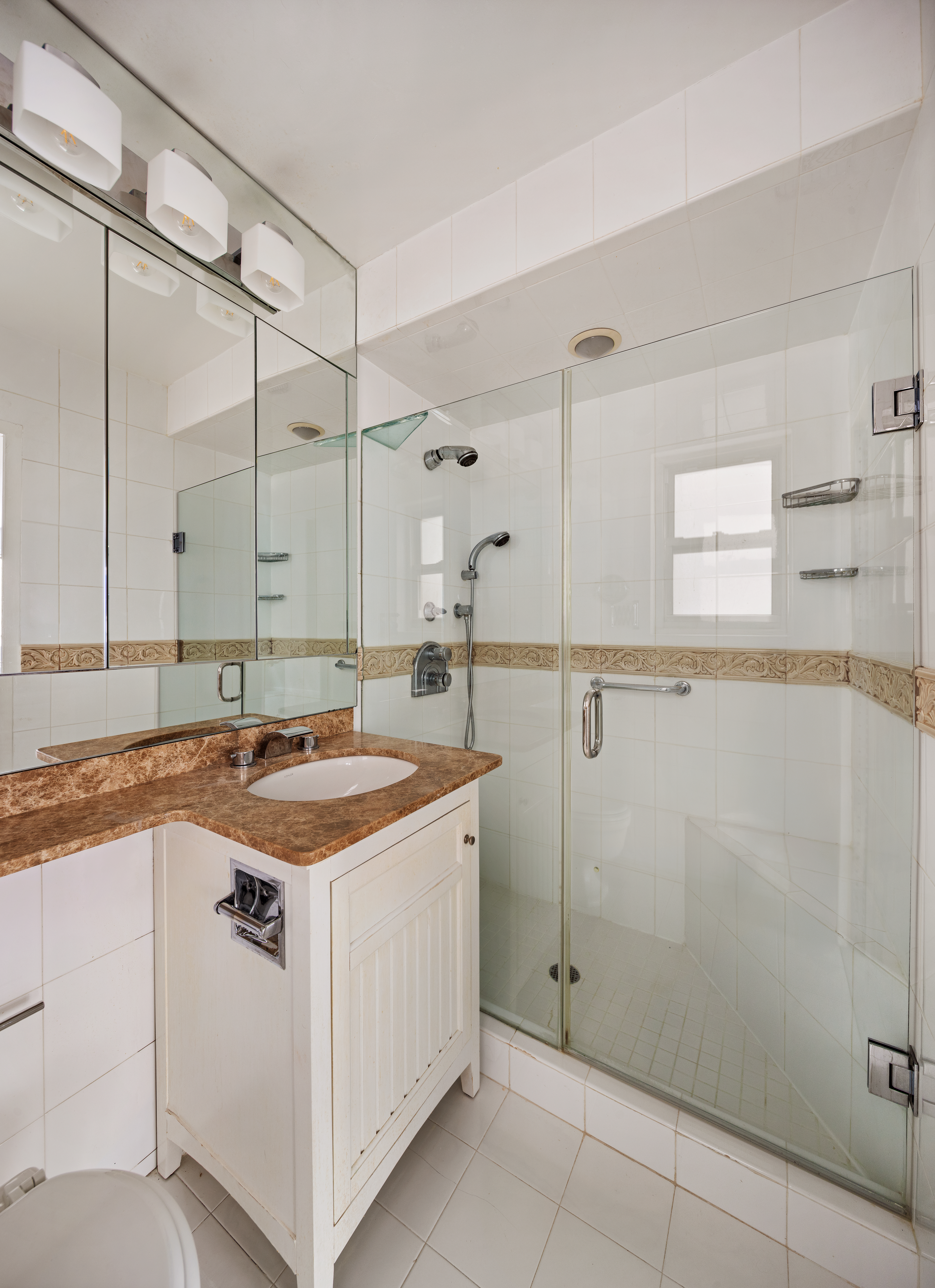 201 East 66th Street, Unit 2E Manhattan, NY 10065 - Photo 13 of 15 a kitchen with a sink stove and cabinets
