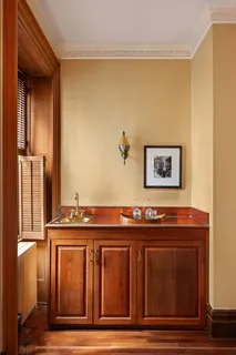 a view of a kitchen with wooden floor and a sink