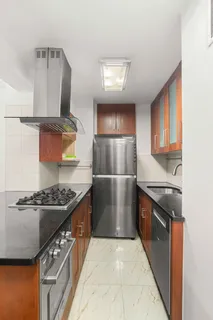 a kitchen with stainless steel appliances granite countertop a stove a sink and a refrigerator