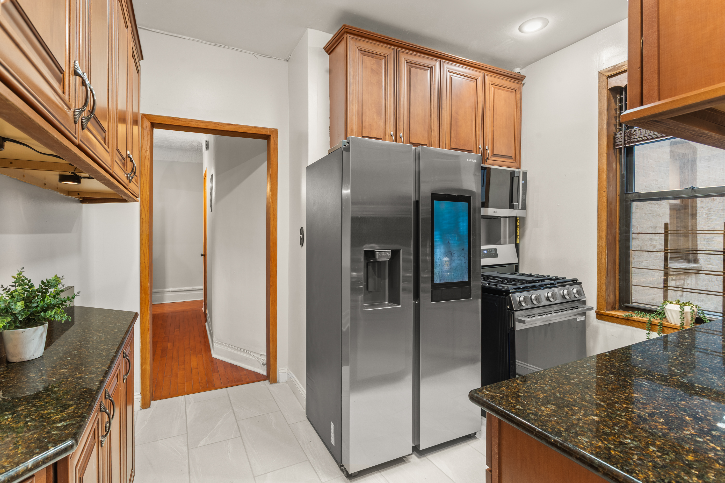527 West 143rd Street, Unit 31 Manhattan, NY 10031 - Photo 7 of 29 a kitchen with stainless steel appliances granite countertop a refrigerator a stove and a sink
