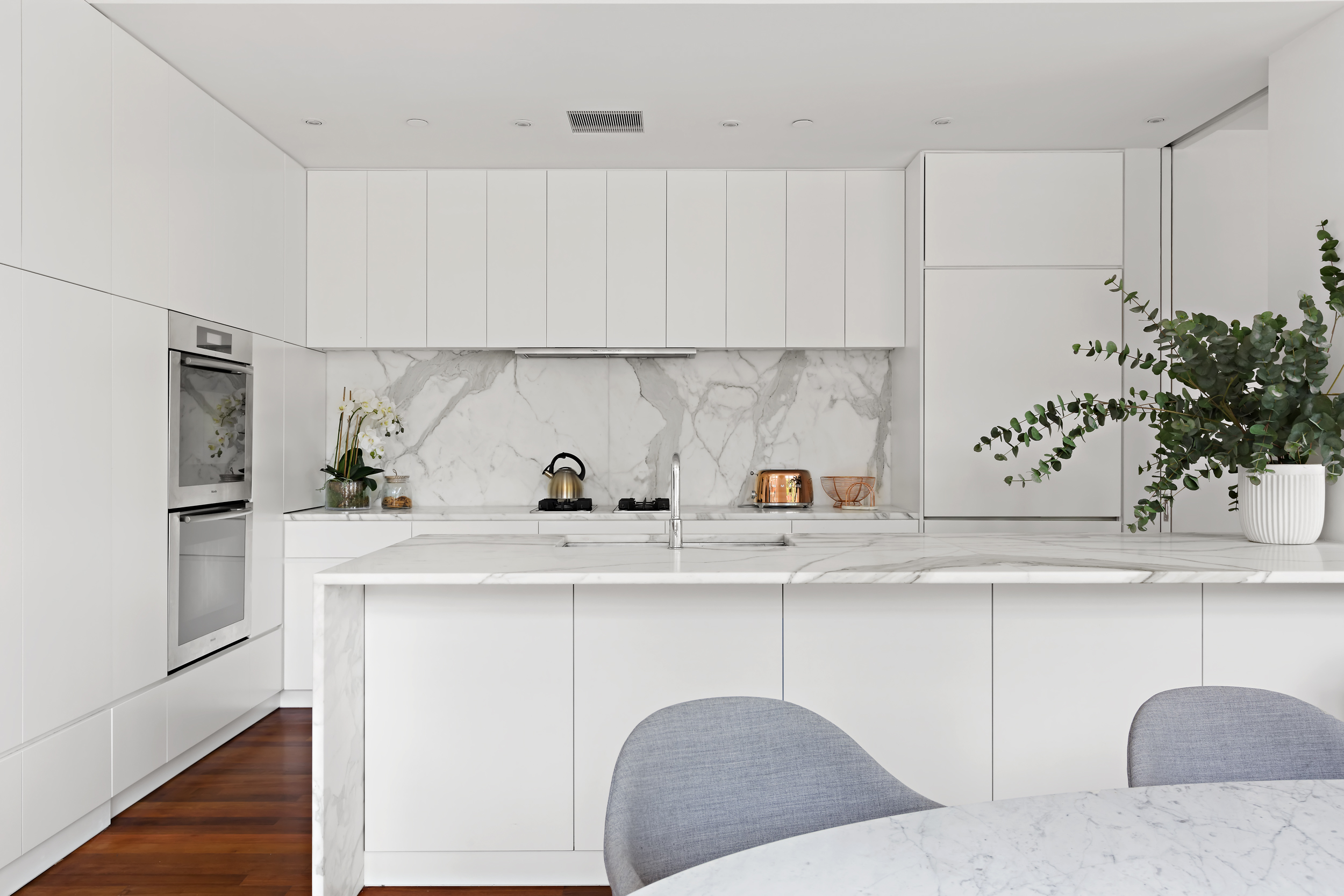 744 Greenwich Street, Unit 4 Manhattan, NY 10014 - Photo 12 of 34 a kitchen with stainless steel appliances granite countertop a sink a refrigerator and white cabinets