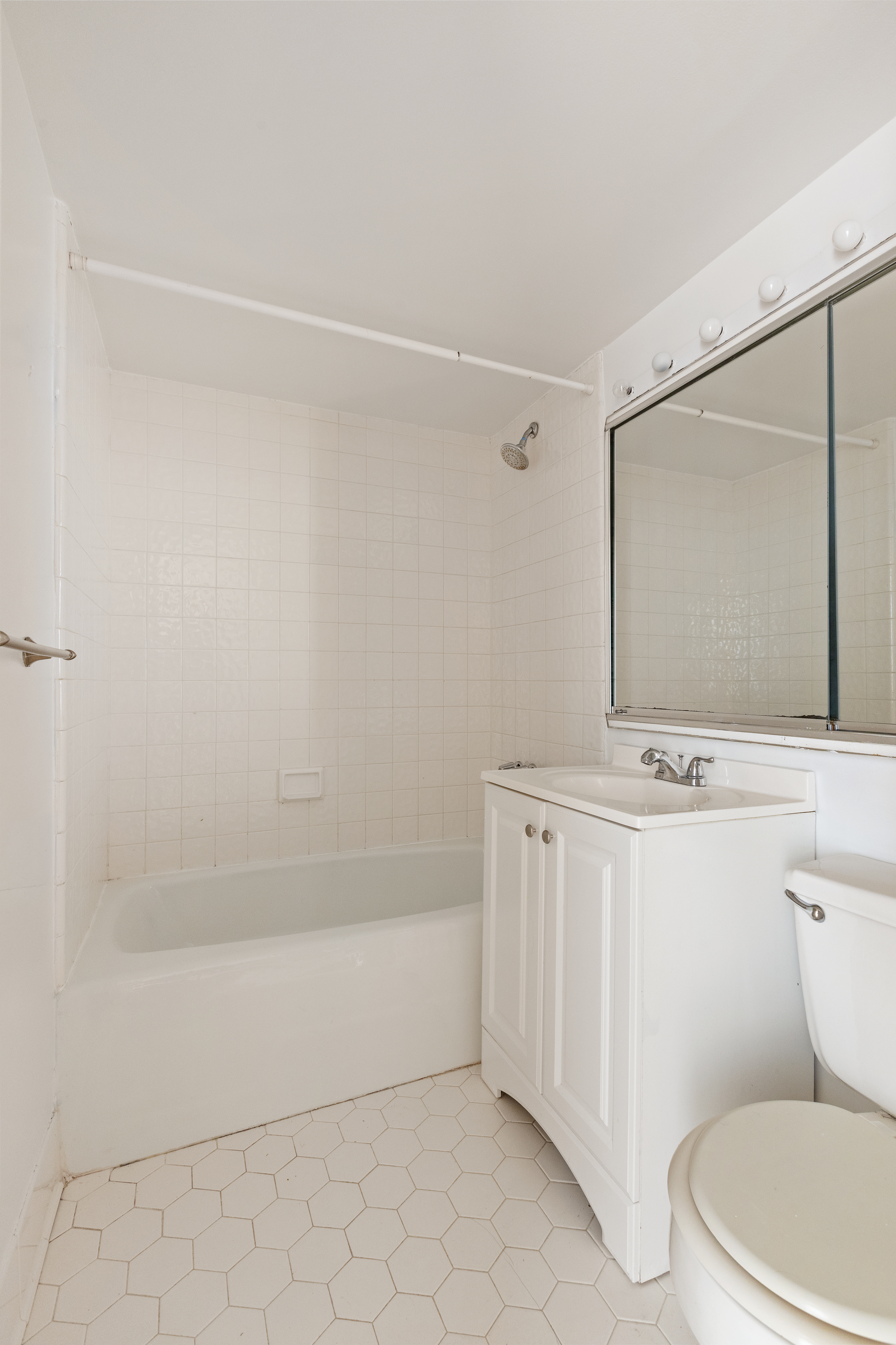 257 West 93rd Street, Unit 3C Manhattan, NY 10025 - Photo 9 of 20 a bathroom with a sink a toilet and vanity