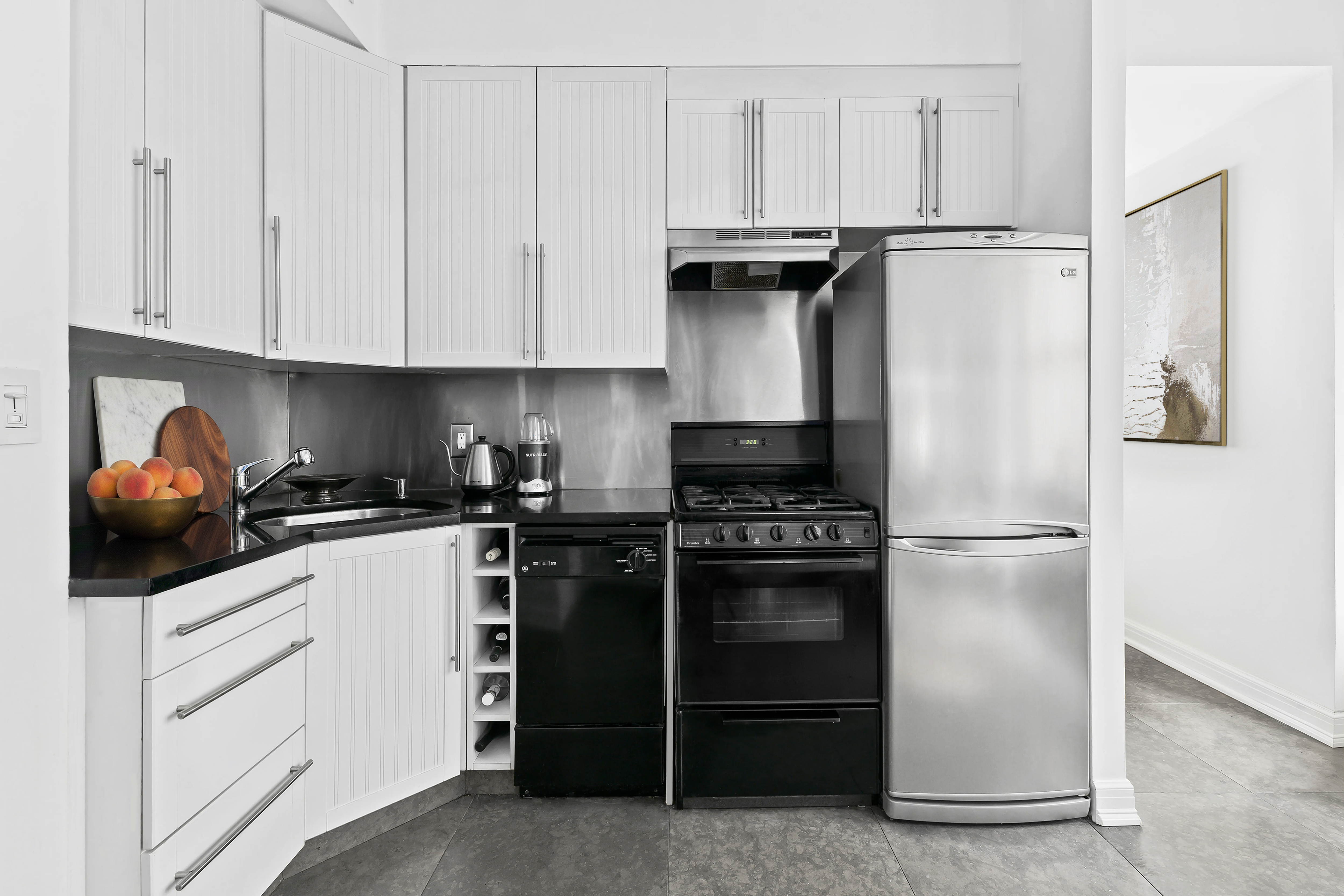 4 Lexington Avenue, Unit 8J Manhattan, NY 10010 - Photo 3 of 8 a kitchen with white cabinets and white appliances