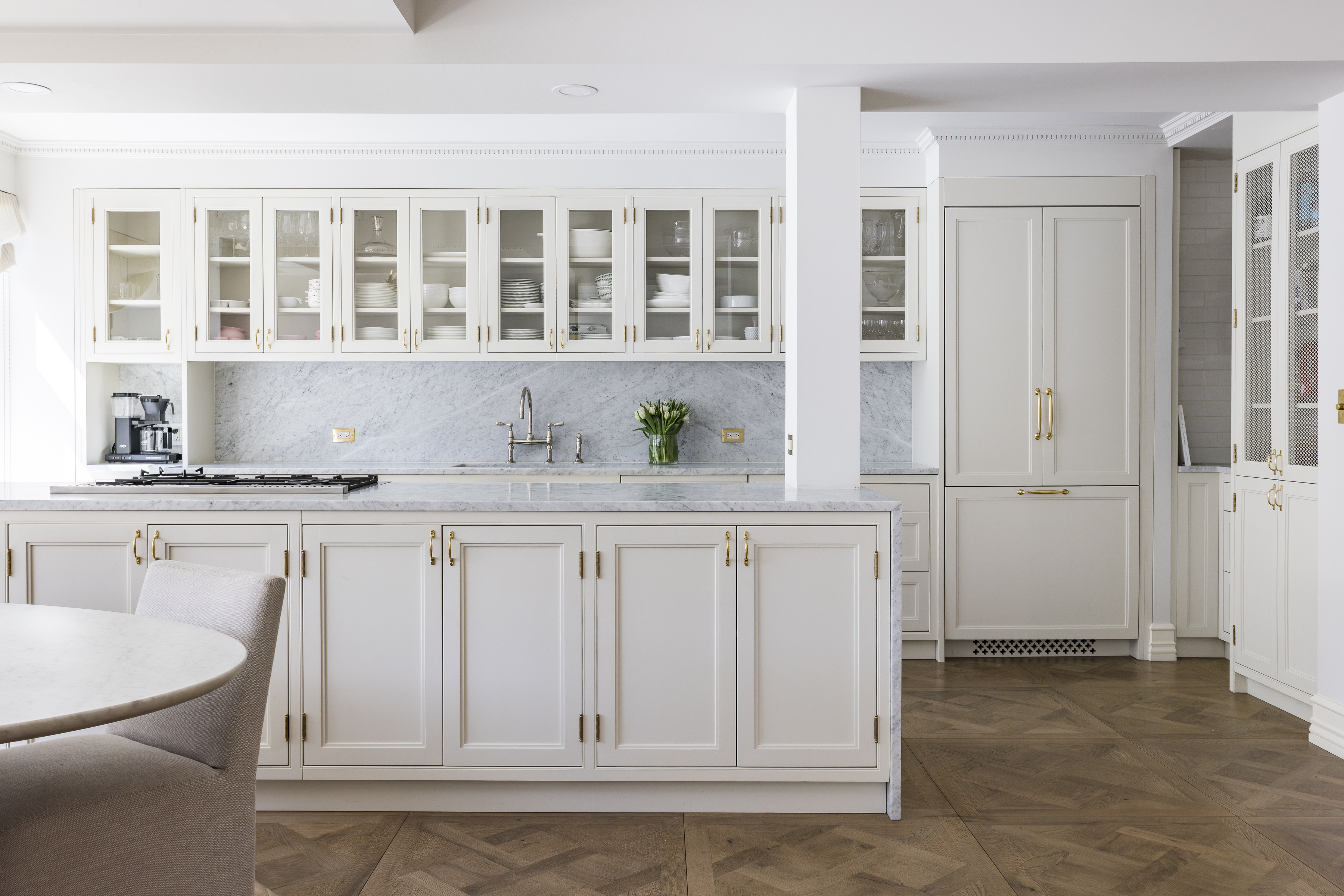 47 East 87th Street, Unit 7A Manhattan, NY 10128 - Photo 2 of 22 a kitchen with white cabinets and sink