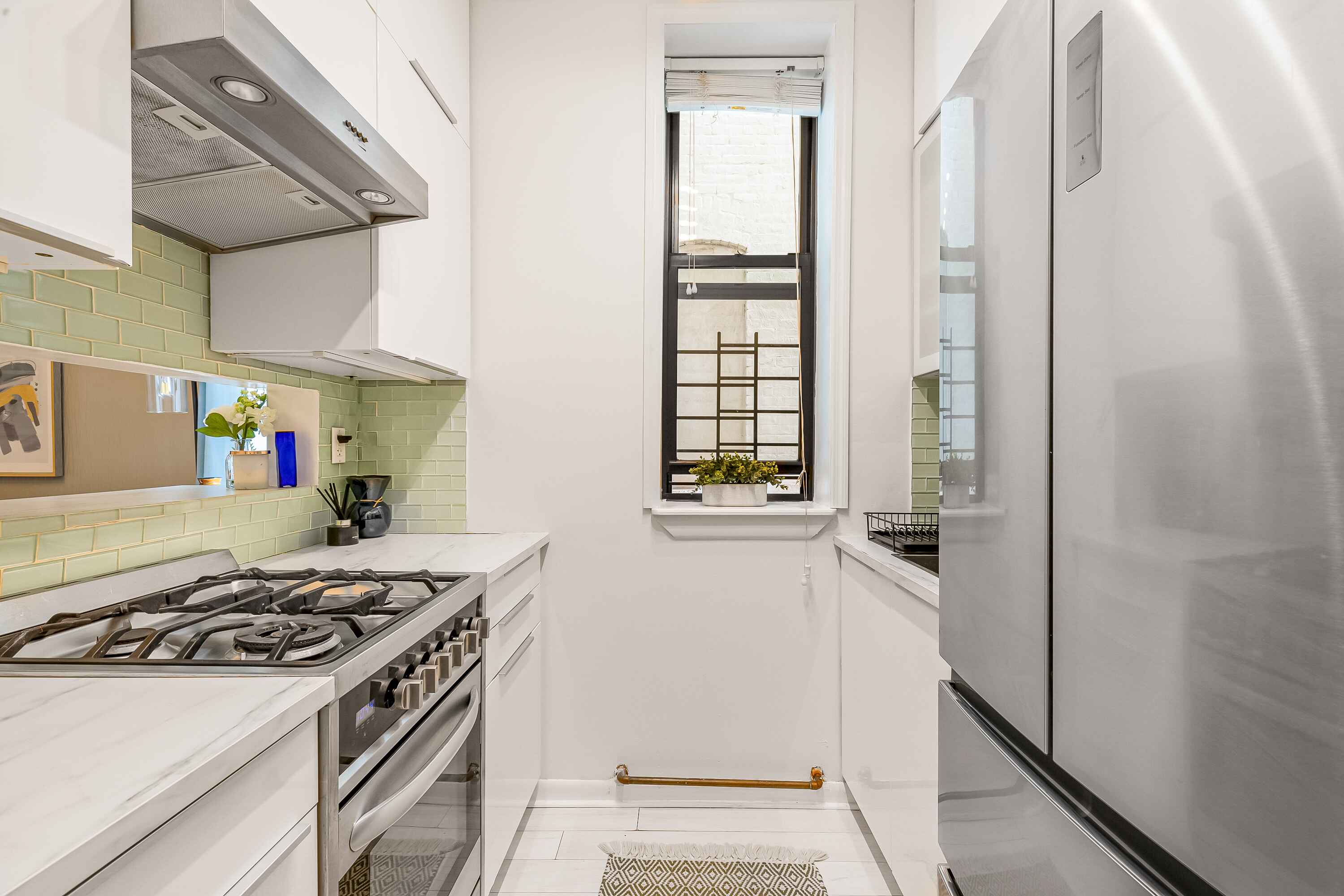 108 West 114th Street, Unit 4B Manhattan, NY 10026 - Photo 6 of 11 a kitchen with a stove and a refrigerator